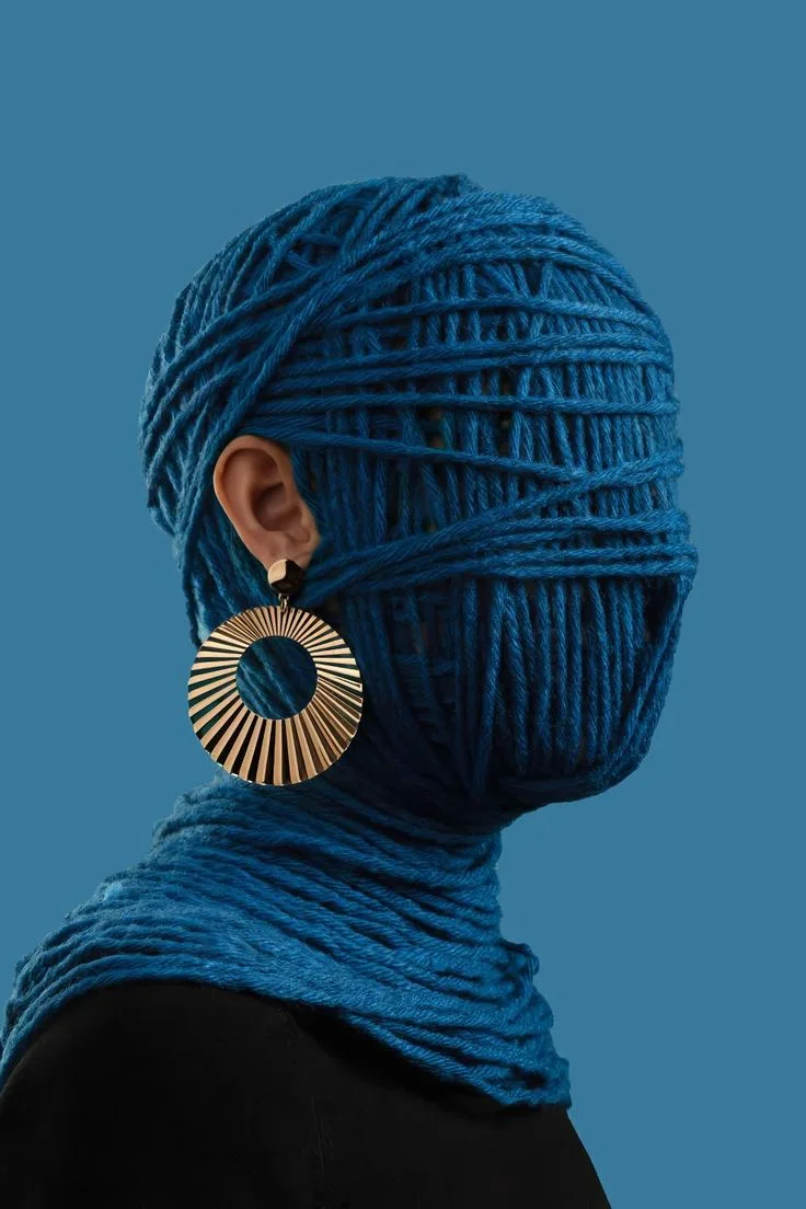 Portrait wrapped in blue thread used as an abstract creative identity reference.